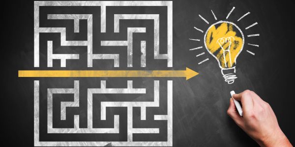 Maze with a direct arrow leading to a light bulb idea.