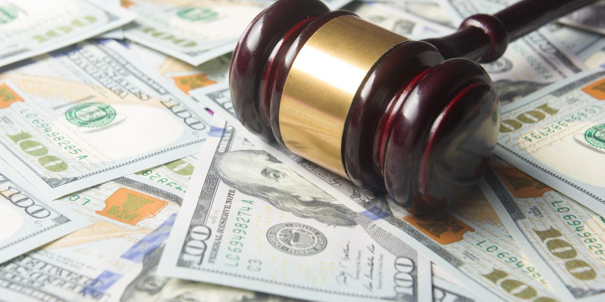 Gavel on US hundred dollar bills.