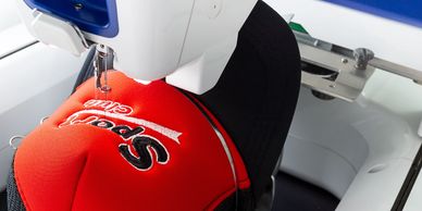 Hat being embroidered at South Philly Tees, showcasing high-quality custom embroidery.