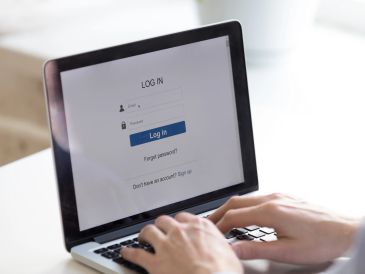 Person logging into an account on a laptop.