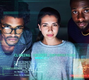Three individuals analyzing digital data on a screen.