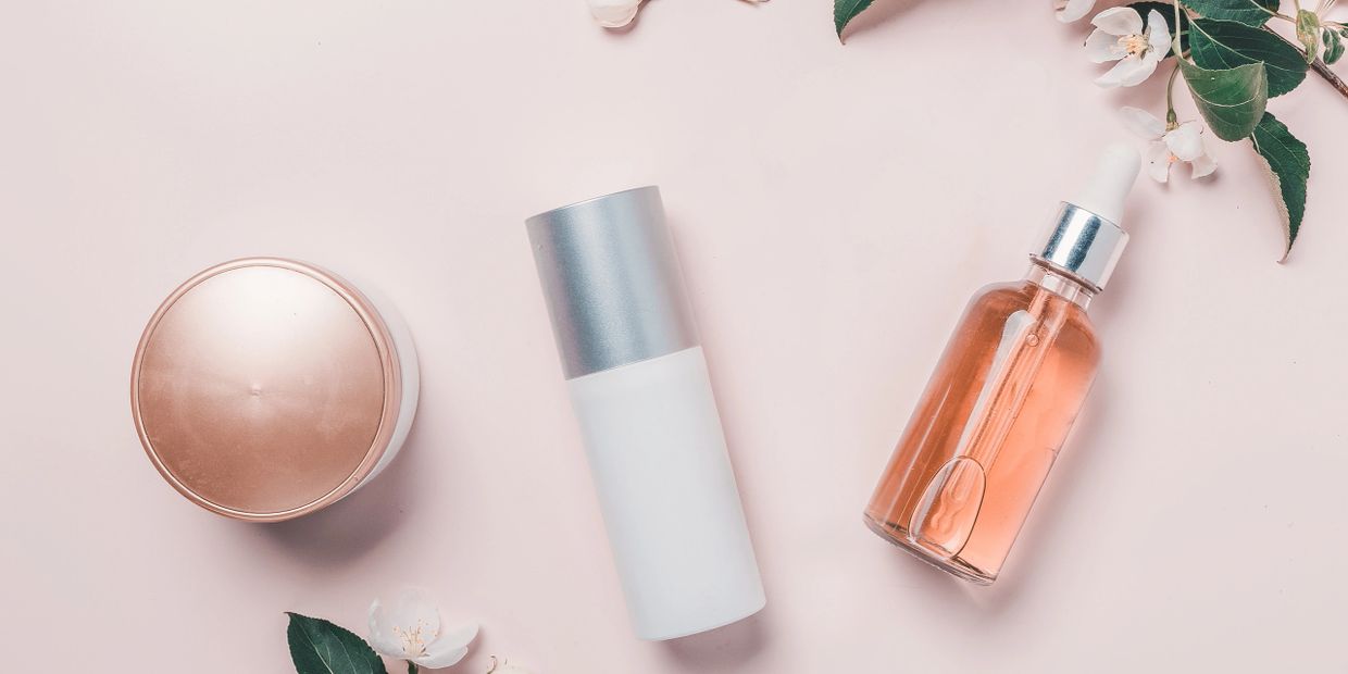 Perfume bottle on table with flowers
