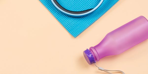 Fitness essentials: yoga mat, headphones, water bottle, and fitness tracker.