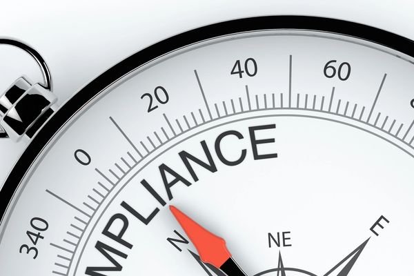 Close-up of a compass with the word 'COMPLIANCE' replacing the north direction.