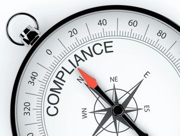 A compass with the word 'COMPLIANCE' replacing the usual directions.
