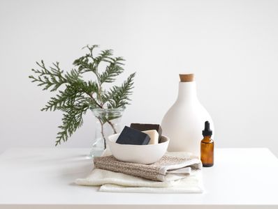 Minimalist vignette with folded linens
and plant representing Élayra’s refined home textiles