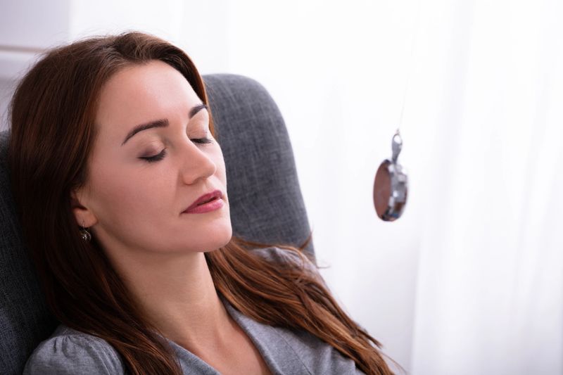 Attractive Young Woman Being Hypnotized With Pendulum At Home