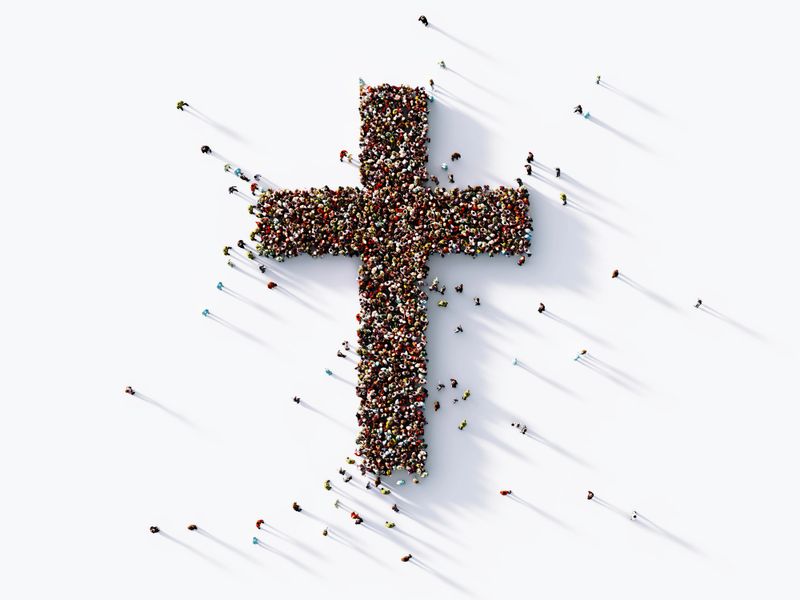Human crowd forming a cross shape on white background. Horizontal  composition with copy space. Clipping path is included. Faith and social Media concept.