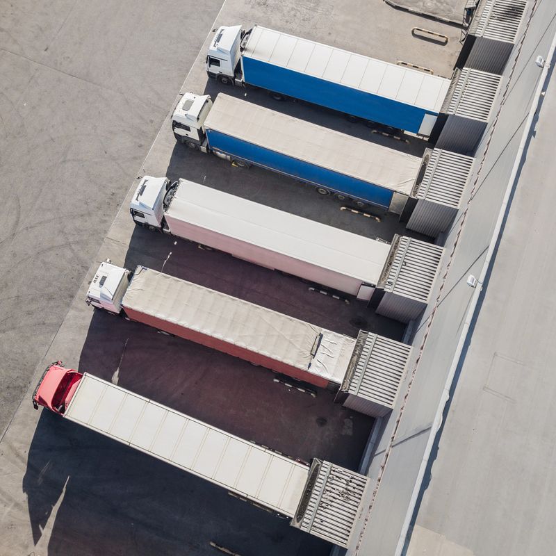 Aerial view of trucks unloading in logostics center