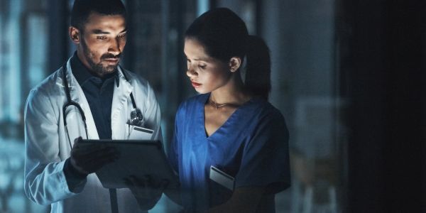 Two medical professionals reviewing patient information.