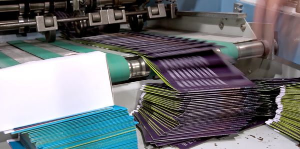 Image of happy business professionals verifying quality of toner cartridges.