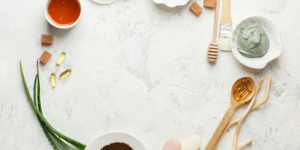 Natural skincare ingredients arranged in a circle on a white surface.