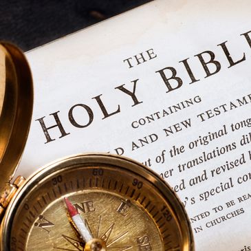 The Holy Bible with a compass.