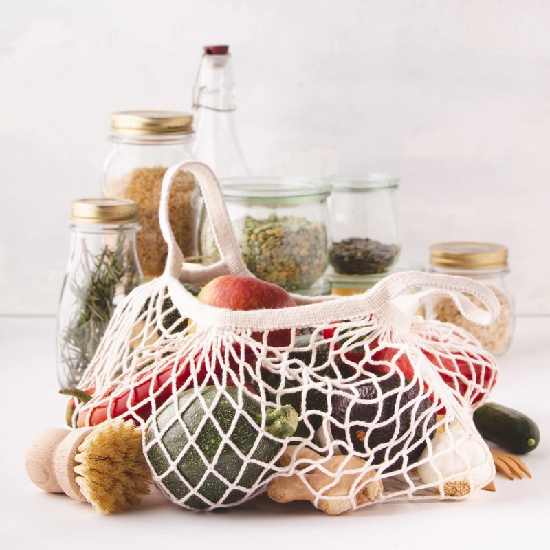 Fruits and vegetables in reusable cotton bags and glass jars with pasta, lentils, beans, rice, dry herbs. Zero waste, Recycling, Sustainable lifestyle concept