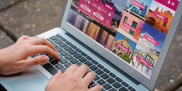 Person browsing travel destinations on a laptop.