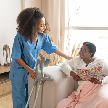 Lying on sofa. Aged woman with leg injury lying on sofa and talking to pleasant caring nurse
