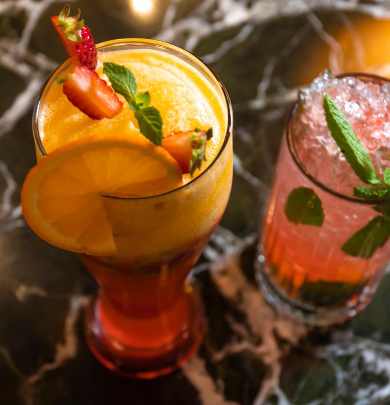 Cold sweet summer fruit juice cocktail glass.