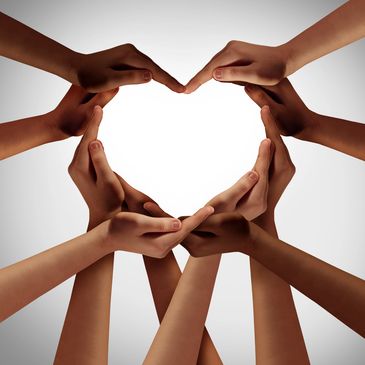 Hands of diverse skin tones forming a heart shape together.
