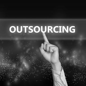 Hand pointing to the word 'OUTSOURCING' on a digital screen.