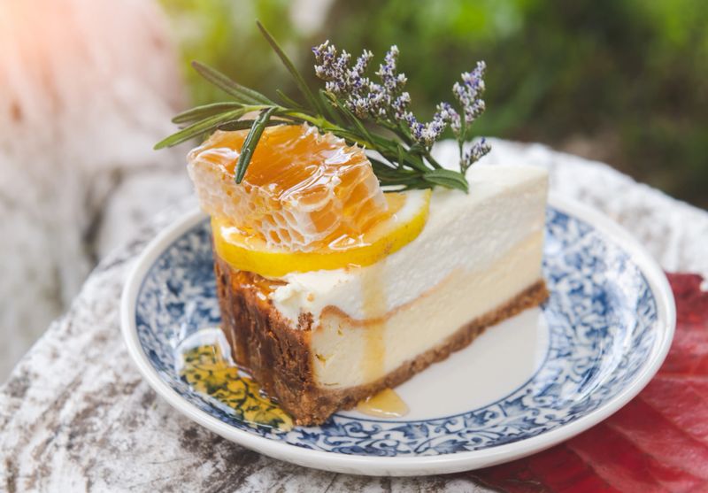 Honey cheese cake with beehive topping serve in vintage plate with outdoor sun lighting.