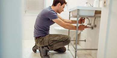 Handyman repairing bathroom sink plumbing and fixtures in Los Gatos.