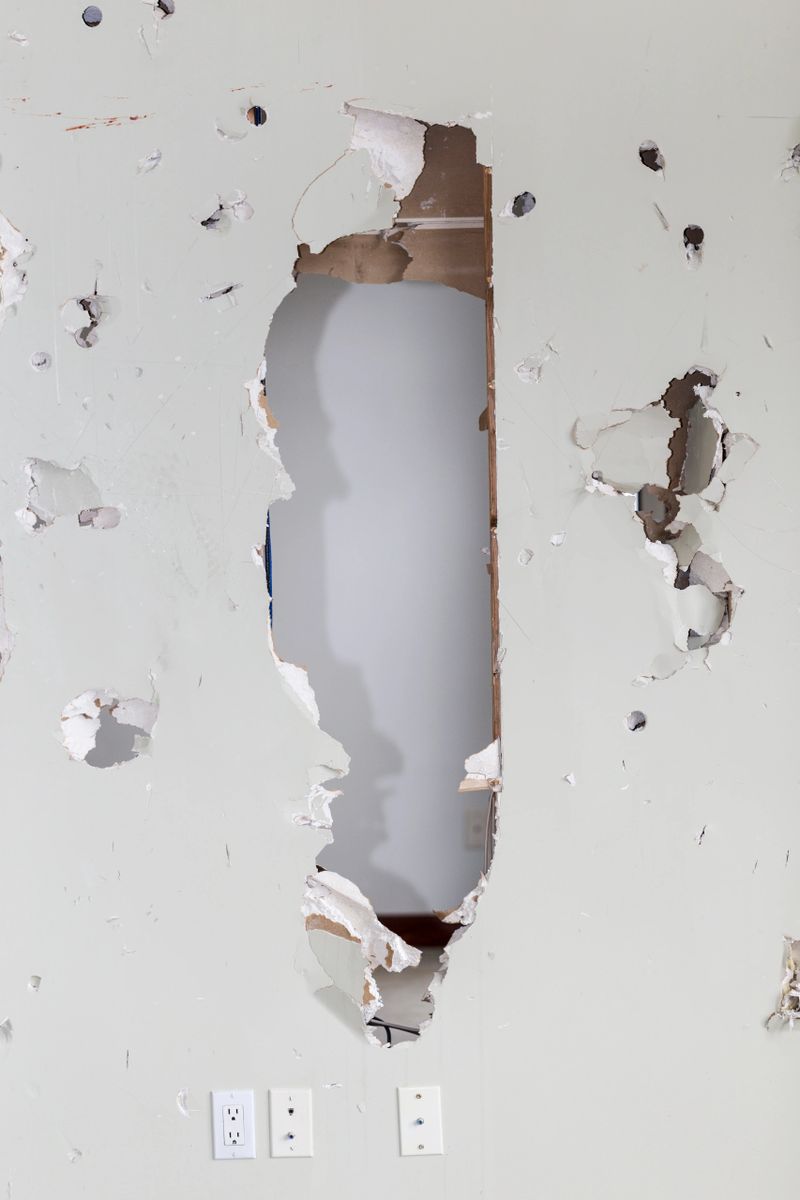 Hole in a sheetrocked - drywall - wall. Vandalism.
