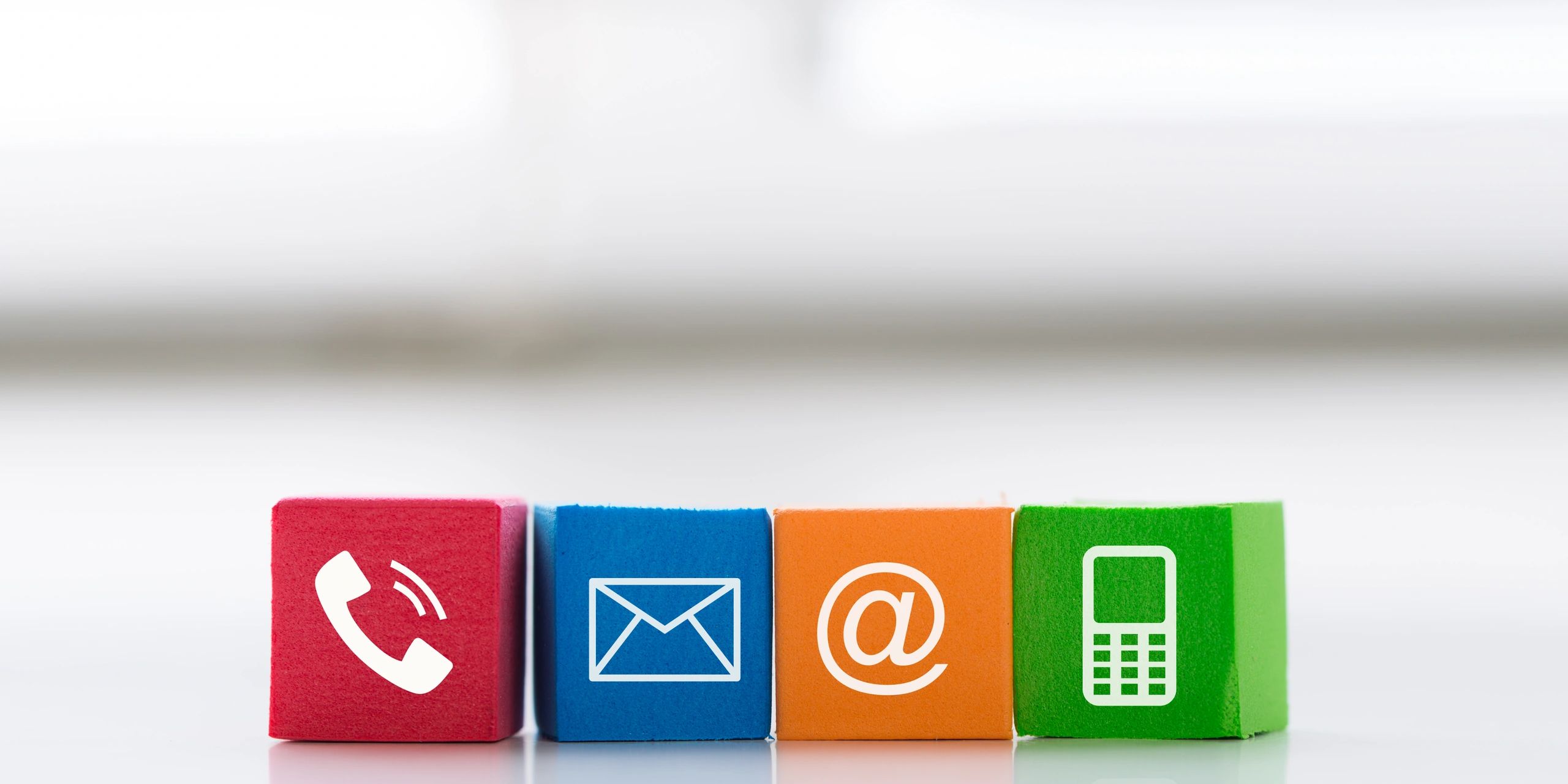 Colorful blocks displaying icons for phone, email, and mobile communication.