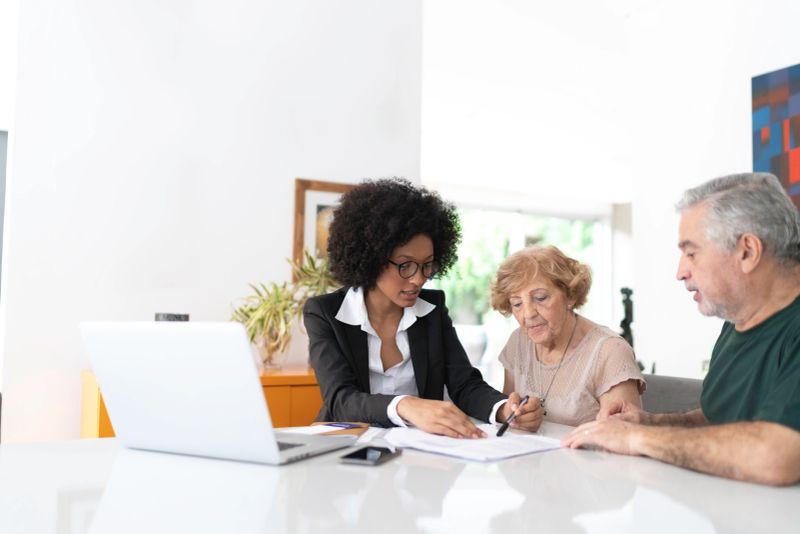 Financial advisor helping a senior couple at home