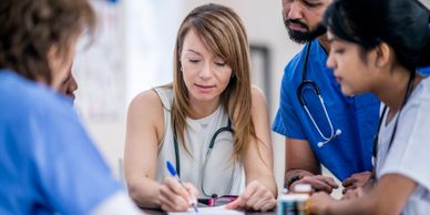 Medical team discussing patient care in a meeting.