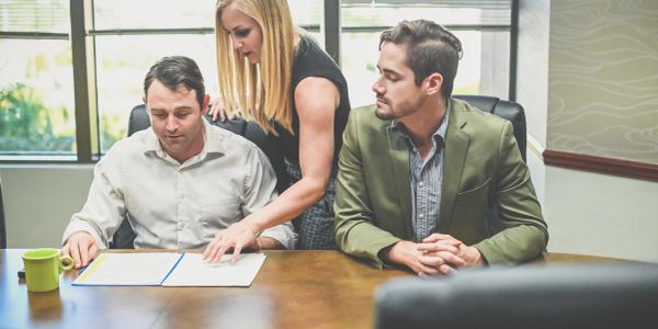 Business professional providing notary services in office.