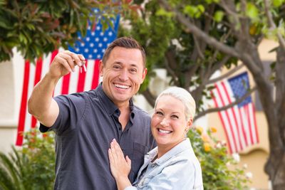 Couple holding keys to a home