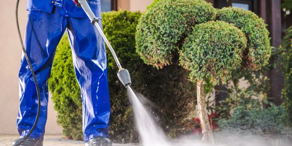 Power washing driveway in Cape Coral, FL by Elevated Surfaces removing dirt, mold, and stains.