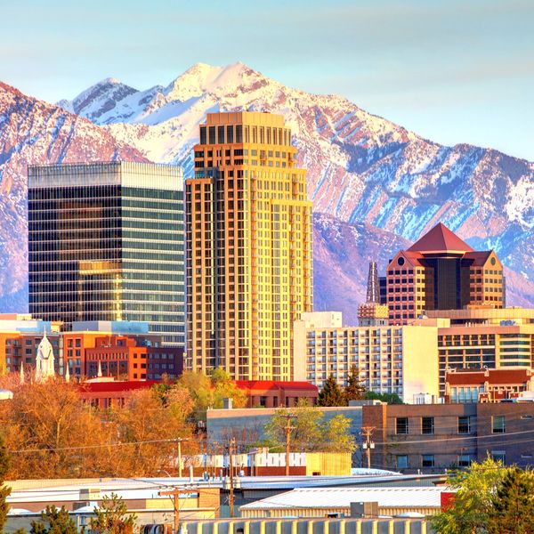 Salt Lake City skyline with mountains, showcasing a major hub for conventions and events.