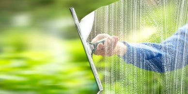 Hand interacting with a digital screen displaying data streams.