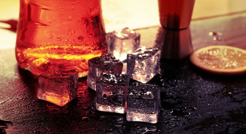 cocktail ice reflections drops light background .