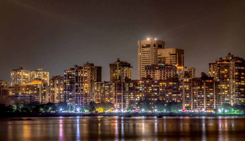 Metropolitan city skyline of a well developed city alongside the coastal area. One of the posh locations in Mumbai which is also termed as the financial capital of India and also is a melting pot. The building depicting the rich culture and extensive use of electricity and posh lifestyle. Tall buildings depicting the population burst.