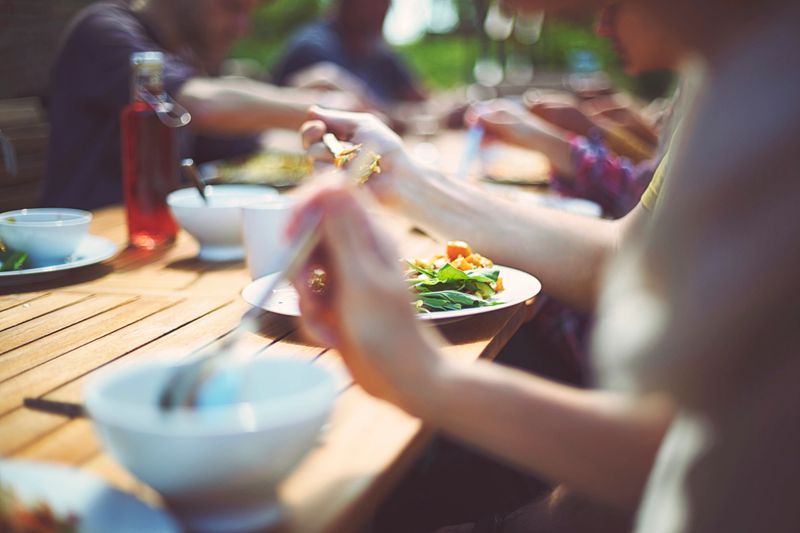 Eating together in the garden with real crockery