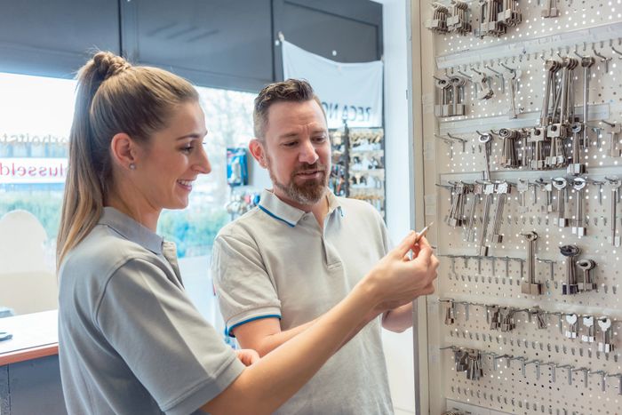 Stack of books next to pencils in a holder and a camera.