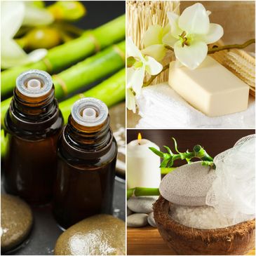 Spa essentials with oils, soap, orchid, candle, and bath salts for relaxation.