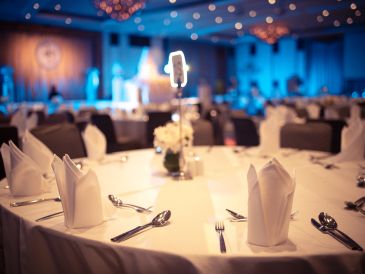 Elegant table setting in a dimly lit banquet hall.