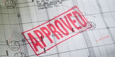 Blueprint with a large red "APPROVED" stamp across the design.