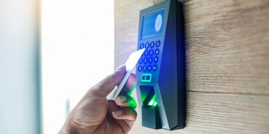 Person using biometric fingerprint scanner for access.