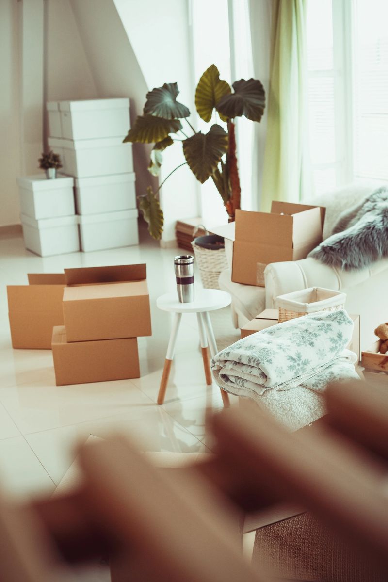 Moving boxes and furniture in new home.