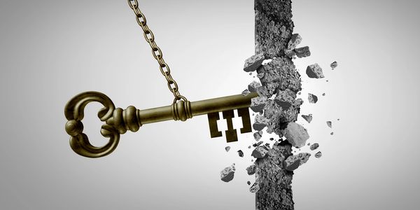 A key breaking through a concrete wall.