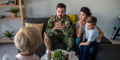 A military man and his family in therapy session with a counselor.