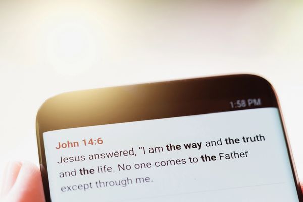 Bible verse John 14:6 displayed on a phone screen.