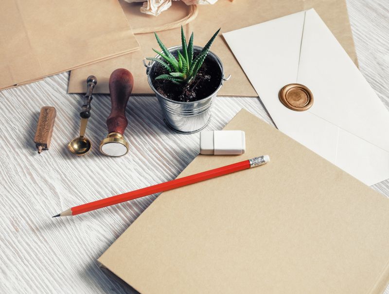 Blank retro stationery set on light wood table background. Mockup for your design.