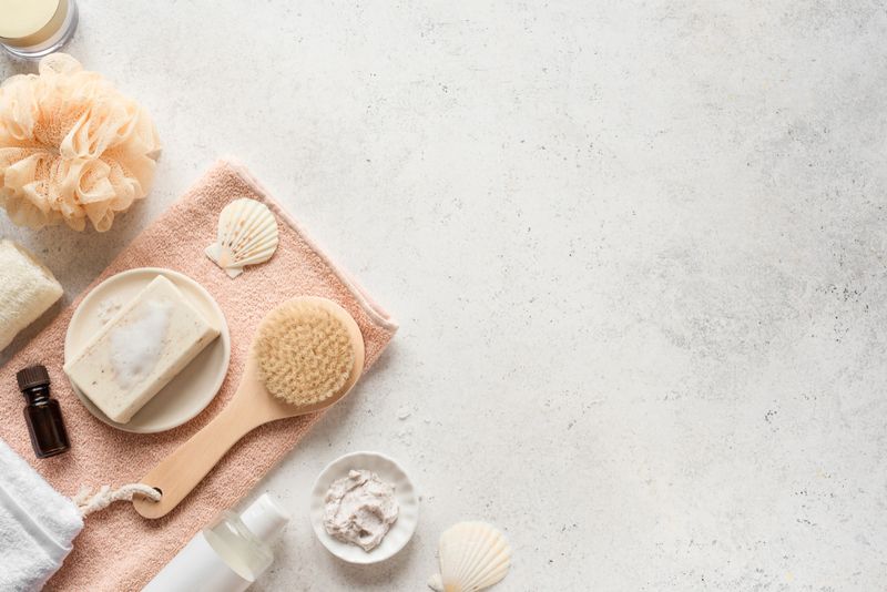 Bath Accessories on white stone background, top view, copy space. Daily bodycare concept, organic bath products.