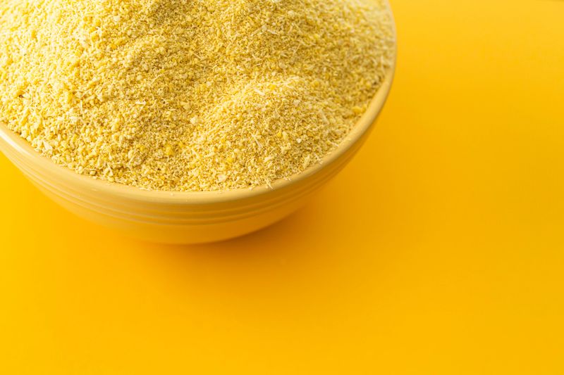 Bowl of Nigerian Yellow Garri in Yellow bowl - Nigerian staple food eaten with local Nigerian soups