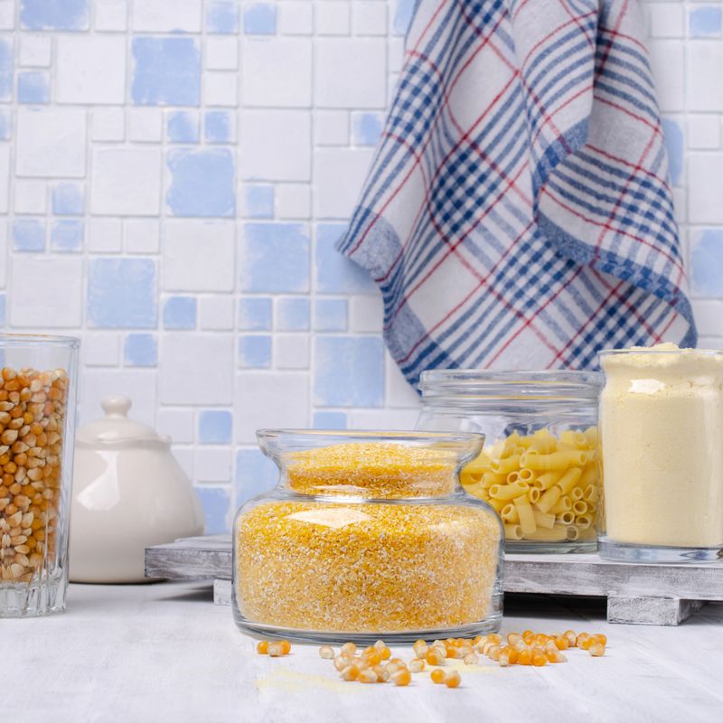 Assorted corn products in a glass jar on a wooden table. Selective focus.